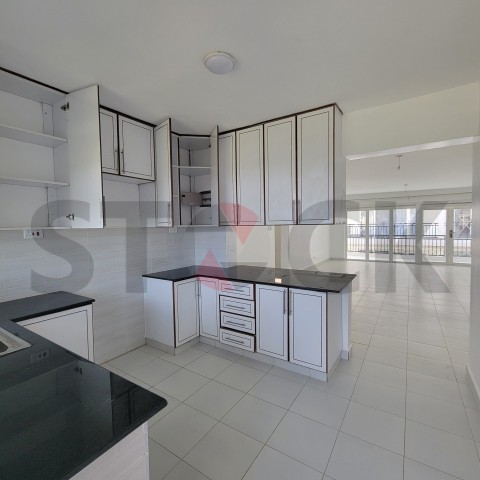 Kitchen with white cabinets and white wall